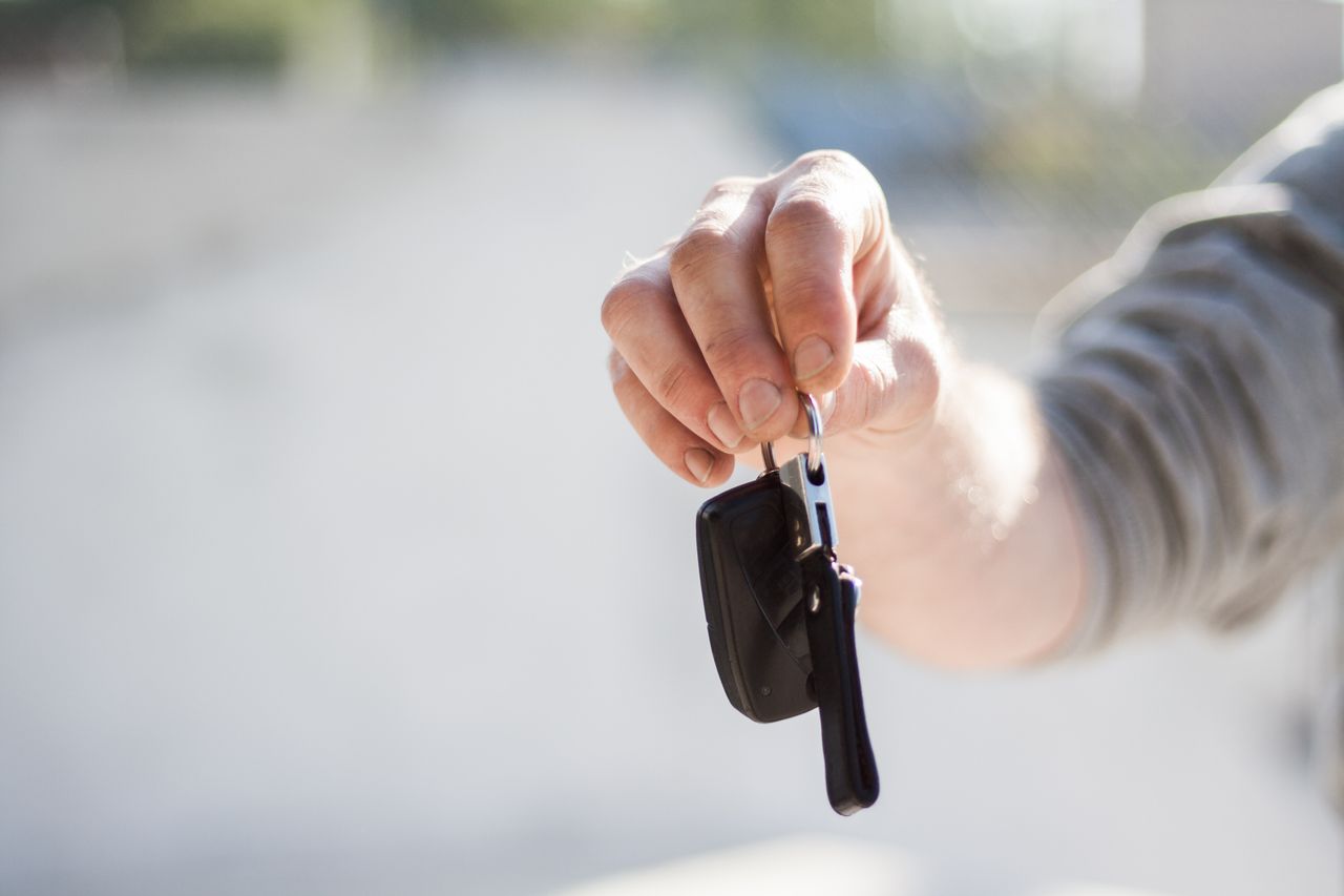 Handing over car keys for a safe Red Nose tow home in Calgary