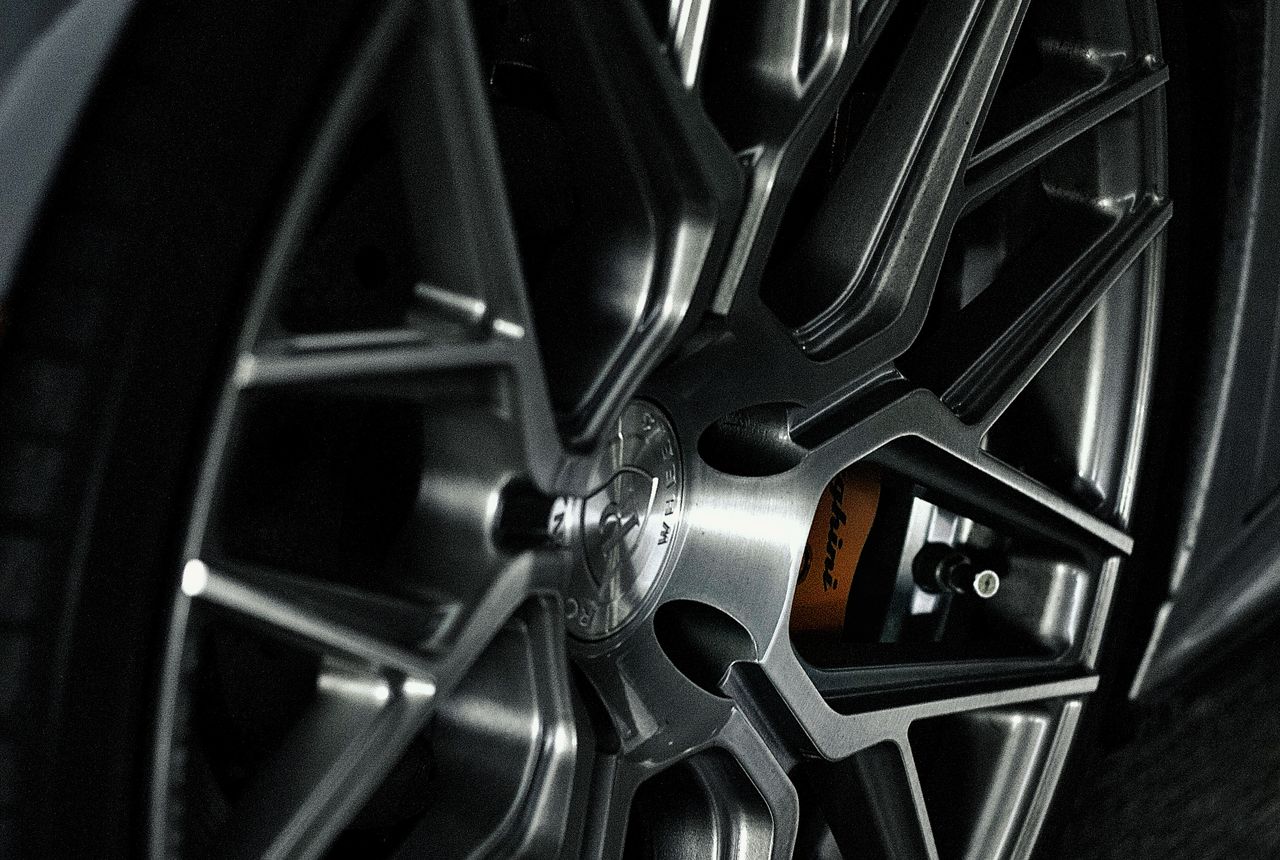 Alloy wheel in Calgary with locking lug nuts being removed during tire service