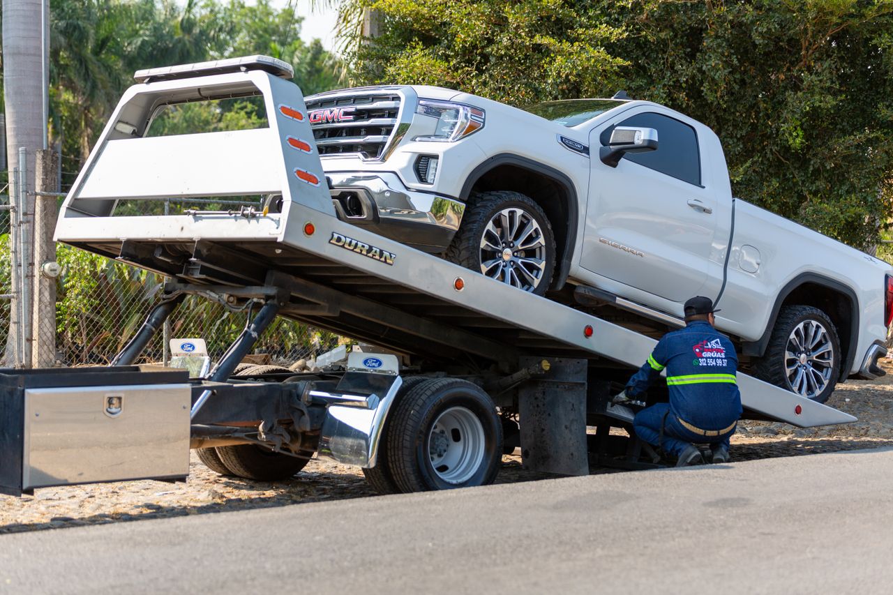 Full-size pickup loaded on a flatbed for SUV and truck towing in Calgary